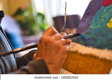 Older Woman Painting At Home For Entertainment