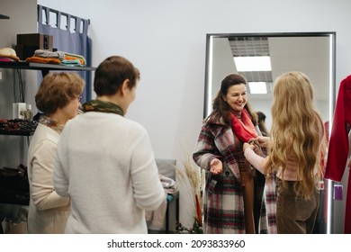 Older Woman Picking Clothes In A Store.