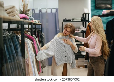 Older Woman Picking Clothes In A Store.