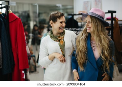 Older Woman Picking Clothes In A Store.