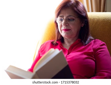 Older Woman Reading The Bible At Home Happy