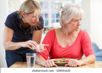 Older Woman Refusing Medication At Home