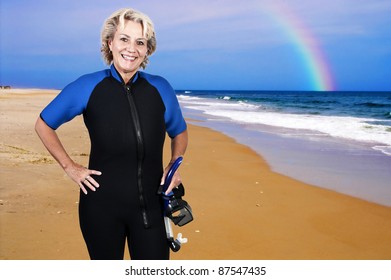 An Older Woman In Scuba Wet Suit With A Mask And Snorkel