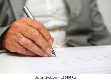 older woman signing the document