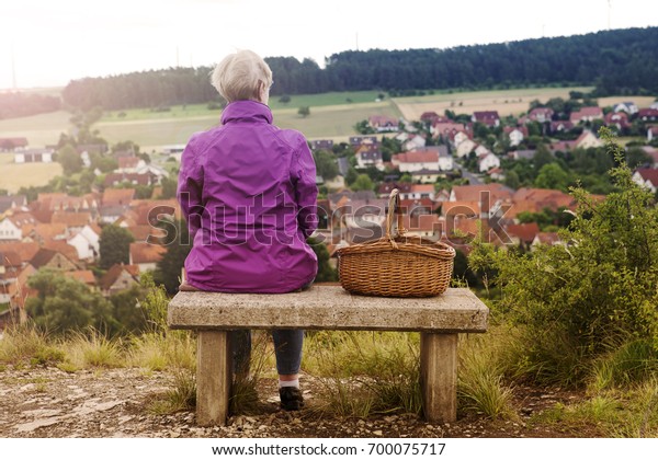 Older Woman Sitting On Bench Looking Stock Photo Edit Now 700075717