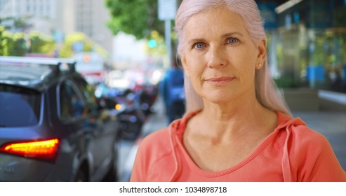 An Older Woman Stands On A San Francisco Street Corner