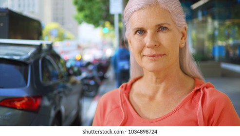 An Older Woman Stands On A San Francisco Street Corner