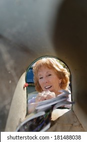 Older Woman Taking Mail Out Of Mailbox