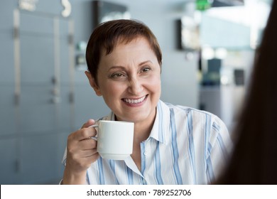 Older Woman Talking To Her Colleague. Business Women Having A Meeting At Lunch Or Coffee Break.