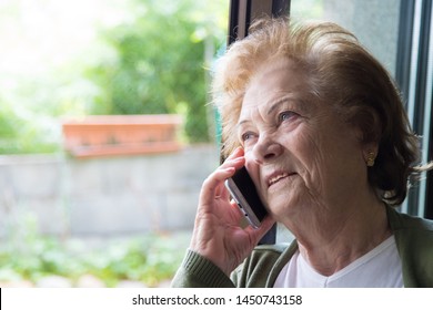 Older Woman Talking On The Cell Phone Or Smartphone