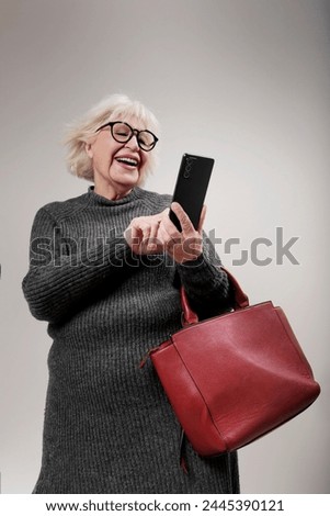 older woman talking on mobile phone and purse