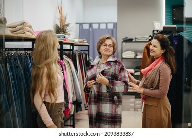 Older Woman Trying On Clothes In The Dressing Room Of A Clothing Store