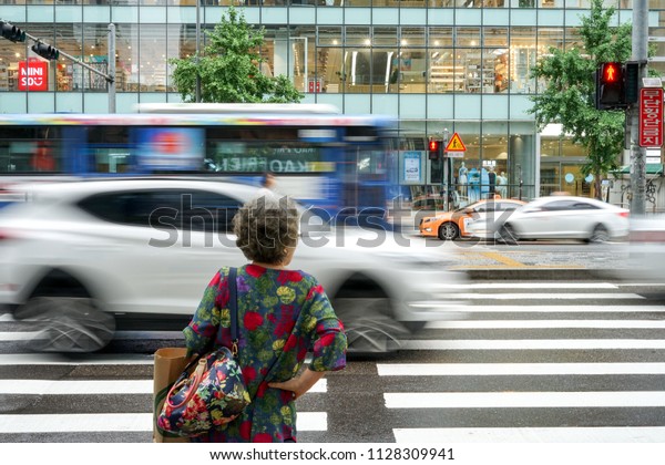 A older woman waiting for cross the road,\
Hongdae , South Korea - Jul 1 ,\
2018