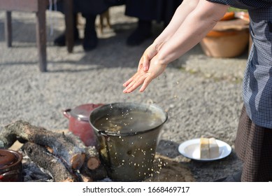 Older Woman Washing Her Hands In Water Heated On Fire