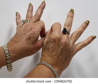 An Older Woman Wearing Jewelry Signing The Word 