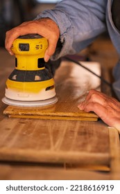 Older Woman With Worn Hands Doing Woodworking With Power Tools, Closeup Of Hands And Wood.