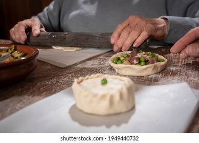 Older Woman And Young Woman Making Traditional Mallorcan Empanadas. Mallorcan Empanadas. Easter Traditions. Hands Doing Culinary Activities.