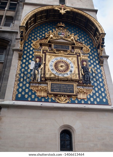Oldest Public Clock in Paris France.Built in the 14\
century by Henri le Vic, a German engineer. Translation, This\
machine, which so justly divides hours, teaches us to support\
justice and protect laws