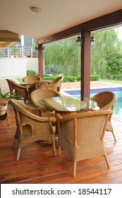 Old-fashioned Cane Chairs And Table In The Garden