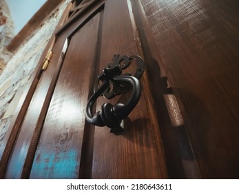 Old-fashioned Vintage Steel Knocker Handle On Old Wooden Door Close Up