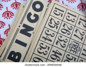 Old-style Bingo cards on an oilcloth table covering.