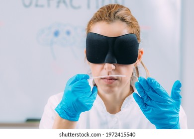 Olfaction. Female Scientist Examining Smells With Mask.