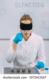 Olfaction. Female Scientist Examining Smells With Mask.