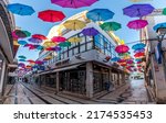 OLHAO, PORTUGAL - June 9th, 2019: Mixed varied colored umbrella decoration through the streets of downtown Olhao city.