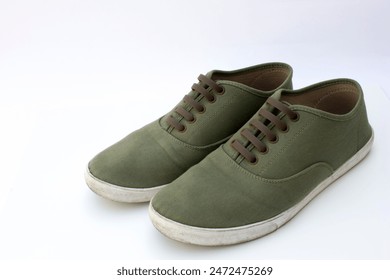 Olive Green Canvas Sneakers: Casual and versatile footwear in a trendy shade. - Powered by Shutterstock