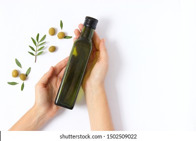 Olive Oil In A Bottle On A White Background Top View.
