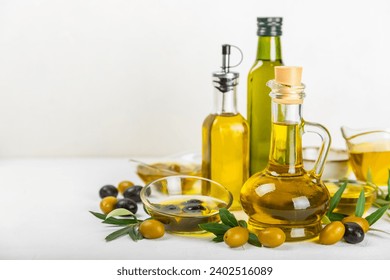 Olive oil in a bottle on a white texture background. Oil bottle with branches and fruits of olives. Place for text. copy space. cooking oil and salad dressing. - Powered by Shutterstock