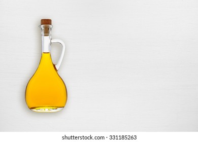 Olive Oil Bottle On White Wooden Table Top View