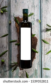 Olive Oil Bottled Mockup On The Wooden Table And Olive Plant