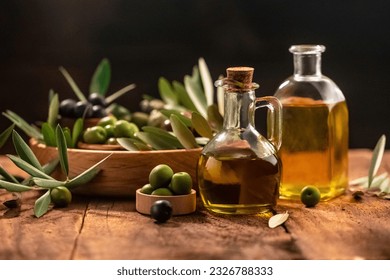 Olive oil in bottles with black and green olives and leaves. extra virgin olive oil jars on a wooden background. place for text. - Powered by Shutterstock