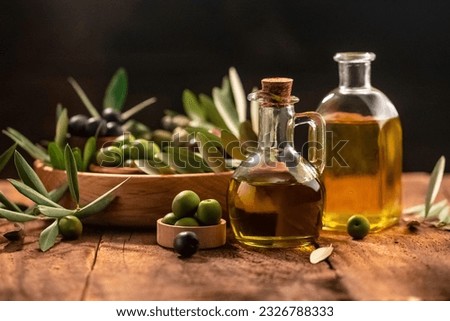 Olive oil in bottles with black and green olives and leaves. extra virgin olive oil jars on a wooden background. place for text. Zdjęcia stock © 