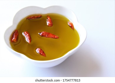 Olive Oil Bowl With Dried Red Chili. Photo Isolate On White Top View Copy Space 