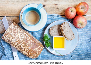 Olive Oil, Bread And Coofe On A Wooden Board