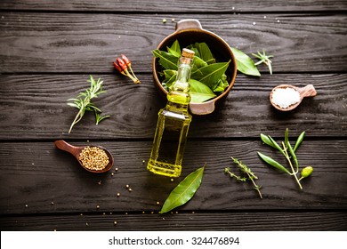 Olive oil with herbs. Mediterranean ingredients: rosemary, olives, thyme, sage, salt, oregano
