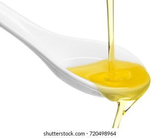 Olive Oil Overflowing From A Spoon Isolated On White