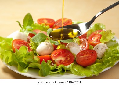 Olive Oil Pouring Over Salad