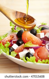 Olive Oil Pouring Over Salad