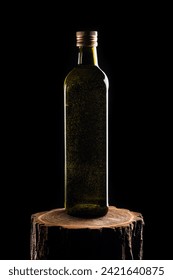Olive oil square bottle on wood stump