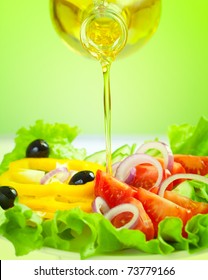 olive oil stream and healthy fresh vegetable salad