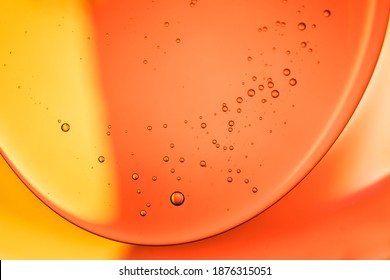 Olive oil and water mixed together abstract bubble macro photography background. Orange color floating bubble gradient closeup pattern