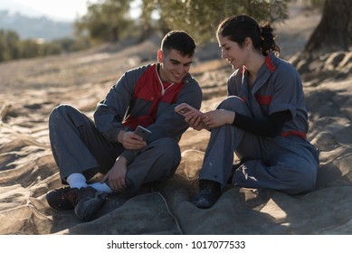  OLive oil workers having a break after work on a mantle with phones - Powered by Shutterstock