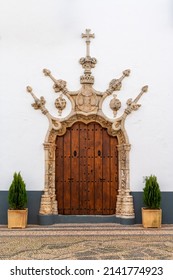Olivenza, Spain - 27 March, 2022: the historic town hall door in the whitewashed village of Olivenza with its ornate stonework arch