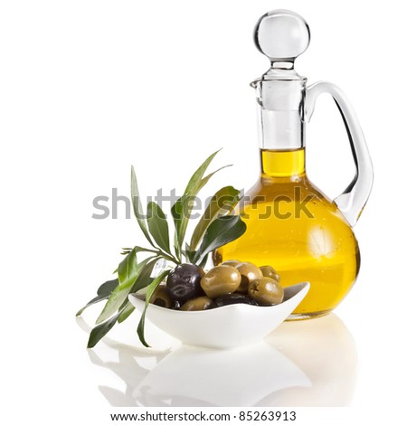 olives branch on bowl and  olive oil decanter  on white background