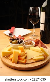 Olives, cheese and a glass of red Wine on a wooden restaurant table