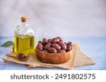 Olives kalamata in wooden bowl and olive oil