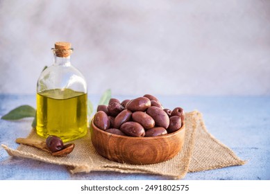 Olives kalamata in wooden bowl and olive oil - Powered by Shutterstock